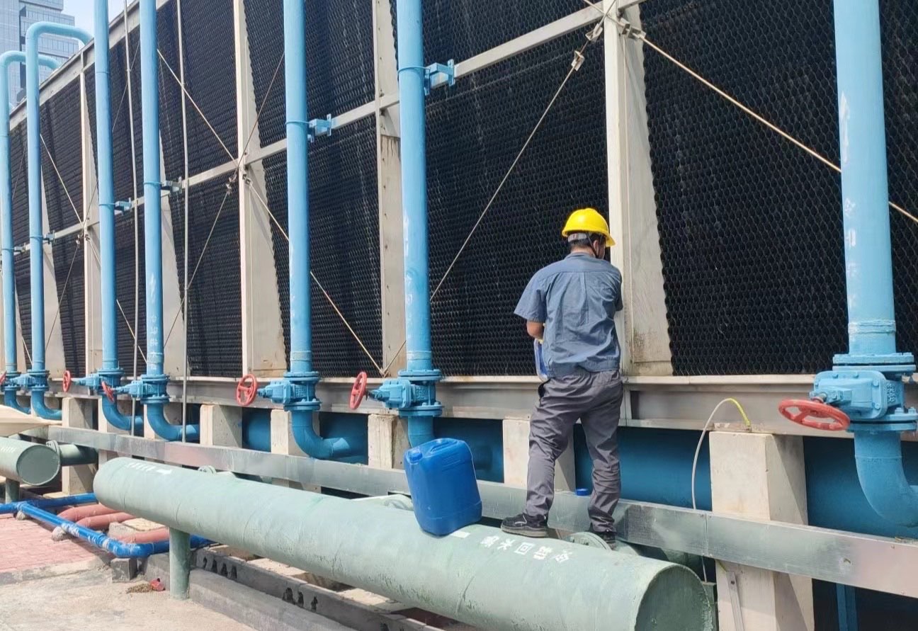 Teknisi memeriksa cooling tower dan jalur cooling water return